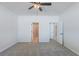 Bright bedroom featuring a ceiling fan, neutral carpeting, and multiple doorways at 549 Honeyhill Loop, Conway, SC 29526