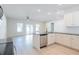 Open-concept kitchen with stainless steel appliances, granite countertops, and seamless flow to the living area at 549 Honeyhill Loop, Conway, SC 29526