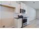 Modern kitchen featuring stainless steel appliances, sleek white cabinets, and stylish backsplash with great lighting at 549 Honeyhill Loop, Conway, SC 29526