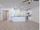 Open living area featuring white cabinets, kitchen island and modern lighting at 549 Honeyhill Loop, Conway, SC 29526