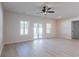 Bright open living room featuring a ceiling fan and sliding glass doors to the backyard at 549 Honeyhill Loop, Conway, SC 29526