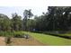 Beautiful aerial view of a low lying marshy area bordered by grassy areas and a lush treeline at 553 Honeyhill Loop, Conway, SC 29526
