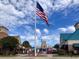 Exterior view of shopping center with American Flag waving against cloudy blue sky at 553 Honeyhill Loop, Conway, SC 29526