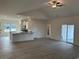 Spacious living area with hard wood floors, stainless appliances, kitchen island, and glass sliding door at 553 Honeyhill Loop, Conway, SC 29526