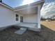Covered back patio with concrete flooring and ceiling fan is perfect for outdoor entertaining and relaxing at 553 Honeyhill Loop, Conway, SC 29526