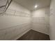 Spacious walk-in closet featuring carpeted floors and multiple rows of sturdy wire shelving for optimal storage and organization at 553 Honeyhill Loop, Conway, SC 29526
