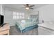 Bedroom features a ceiling fan, window with shutters, and colorful bedding at 5600 North Ocean Blvd. # B-3, North Myrtle Beach, SC 29582