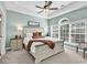 Well-lit bedroom with a tray ceiling, large window, and decorative furniture at 5750 Oyster Catcher Dr. # 1135, North Myrtle Beach, SC 29582
