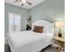 Comfortable bedroom with a queen size bed, ceiling fan, and a side table at 5750 Oyster Catcher Dr. # 1135, North Myrtle Beach, SC 29582