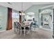 Bright dining room featuring stylish chairs and a view into the modern kitchen at 5750 Oyster Catcher Dr. # 1135, North Myrtle Beach, SC 29582
