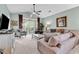 Bright living room boasts vaulted ceilings, plush furniture, and a sliding glass door to the outdoor patio with scenic views at 5750 Oyster Catcher Dr. # 1135, North Myrtle Beach, SC 29582