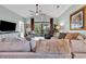 Spacious living room with comfortable seating, a ceiling fan, and a large sliding glass door that opens to a private balcony at 5750 Oyster Catcher Dr. # 1135, North Myrtle Beach, SC 29582