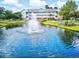 Scenic view of the condo building overlooking a tranquil pond with a fountain feature at 5750 Oyster Catcher Dr. # 1135, North Myrtle Beach, SC 29582