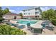 Relaxing community pool with plenty of seating and tables surrounded by lush green landscaping at 5750 Oyster Catcher Dr. # 1135, North Myrtle Beach, SC 29582