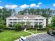 An aerial view shows the condo complex with lush landscaping and parking areas at 5825 Catalina Dr. # 1034, North Myrtle Beach, SC 29582