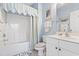 This full bathroom has a tub, blue walls, shower curtain and beach themed accessories at 5825 Catalina Dr. # 1034, North Myrtle Beach, SC 29582