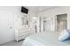 A light bedroom features a dresser with beach decorations and a view to an ensuite bathroom at 5825 Catalina Dr. # 1034, North Myrtle Beach, SC 29582
