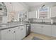 The kitchen offers granite countertops and white cabinets with a view into the living room at 5825 Catalina Dr. # 1034, North Myrtle Beach, SC 29582