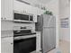 Modern kitchen featuring stainless steel appliances, granite countertops, and white cabinetry at 5825 Catalina Dr. # 1034, North Myrtle Beach, SC 29582