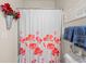 Well-lit bathroom featuring a white shower curtain, a decorative sign and neutral wall paint for a serene space at 6015 Catalina Dr. # 132, North Myrtle Beach, SC 29582