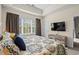 Comfortable bedroom featuring a window with natural light, complemented by tray ceilings and neutral wall paint at 6015 Catalina Dr. # 132, North Myrtle Beach, SC 29582