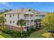 Multi-story condo building with brick accents, white trim, and well-maintained landscaping at 6015 Catalina Dr. # 132, North Myrtle Beach, SC 29582