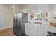 Kitchen view featuring stainless refrigerator, white cabinets, and an open view to the dining and living areas at 6015 Catalina Dr. # 132, North Myrtle Beach, SC 29582
