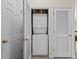 Efficient laundry area showcasing a stacked washer and dryer nestled between two white doors for easy access at 6015 Catalina Dr. # 132, North Myrtle Beach, SC 29582