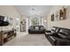 Bright living room featuring a ceiling fan, view to the outside, and comfortable leather seating at 6015 Catalina Dr. # 132, North Myrtle Beach, SC 29582