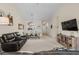 Spacious living room open to kitchen and entry with modern furniture, TV, and shelving at 6015 Catalina Dr. # 132, North Myrtle Beach, SC 29582