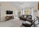 Open living room with a ceiling fan, sliding door, and comfortable leather sofas at 6015 Catalina Dr. # 132, North Myrtle Beach, SC 29582
