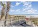Beach access with palm trees and a wooden boardwalk overlooking the ocean at 6100 N Ocean Blvd. # 804, North Myrtle Beach, SC 29582