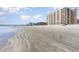 Expansive beach view with a fishing pier and condo buildings in the background on a sunny day with puffy clouds at 6100 N Ocean Blvd. # 804, North Myrtle Beach, SC 29582