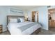 Bright bedroom featuring a comfortable bed and ensuite access to a well-lit bathroom at 6100 N Ocean Blvd. # 804, North Myrtle Beach, SC 29582