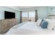 Bedroom with ocean view, flat screen tv, dresser, and king size bed with stylish pillows at 6100 N Ocean Blvd. # 804, North Myrtle Beach, SC 29582