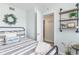 Charming bedroom with a black iron bed frame, striped bedding, and open closet at 6100 N Ocean Blvd. # 804, North Myrtle Beach, SC 29582