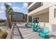 Outdoor deck with turquoise adirondack chairs, tables, and tropical landscaping by the building at 6100 N Ocean Blvd. # 804, North Myrtle Beach, SC 29582