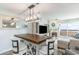 Dining area with table and chairs, lighting fixture, and views into the living room with fireplace at 6100 N Ocean Blvd. # 804, North Myrtle Beach, SC 29582