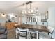 Open-concept dining area with a large table, modern light fixture, and adjoining kitchen at 6100 N Ocean Blvd. # 804, North Myrtle Beach, SC 29582