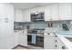 Bright kitchen with white cabinets, stainless steel appliances, and a subway tile backsplash at 6100 N Ocean Blvd. # 804, North Myrtle Beach, SC 29582