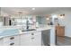 Bright, open kitchen with modern appliances, white cabinets, and a view into the living room and out to the ocean at 6100 N Ocean Blvd. # 804, North Myrtle Beach, SC 29582