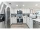 Bright kitchen with white cabinets, stainless steel appliances, and tile backsplash at 6100 N Ocean Blvd. # 804, North Myrtle Beach, SC 29582