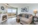 Charming living room featuring a decorative fireplace, comfortable sofa and view of the water at 6100 N Ocean Blvd. # 804, North Myrtle Beach, SC 29582