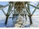 Stunning view underneath the pier with water rippling around support beams and bright sky visible at 6100 N Ocean Blvd. # 804, North Myrtle Beach, SC 29582