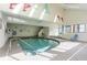 Indoor pool with decorative dolphin wall art and a jacuzzi visible through the window at 6100 N Ocean Blvd. # 804, North Myrtle Beach, SC 29582