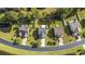An aerial view of several single-Gathering homes with well-manicured lawns and mature trees in a residential neighborhood at 650 Woodman Dr., Conway, SC 29526