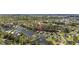 Aerial view showcases the home's location in a lush, wooded community near tranquil ponds and winding roads at 650 Woodman Dr., Conway, SC 29526