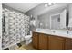 Well-lit bathroom with shower and vanity featuring light wood cabinets and neutral accents at 650 Woodman Dr., Conway, SC 29526