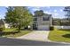 Charming two-story home featuring light siding, a well-manicured lawn, and an inviting driveway at 650 Woodman Dr., Conway, SC 29526
