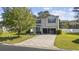 Charming two-story home featuring light siding, a well-manicured lawn, and an inviting driveway at 650 Woodman Dr., Conway, SC 29526